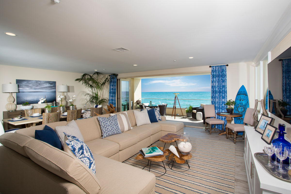 Bright and airy coastal living area with blue accents at The Strand