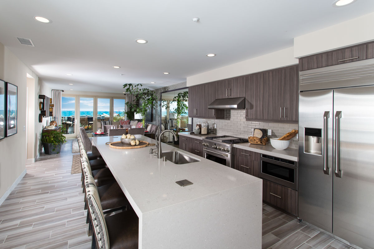 Modern coastal kitchen and island seating area at The Strand