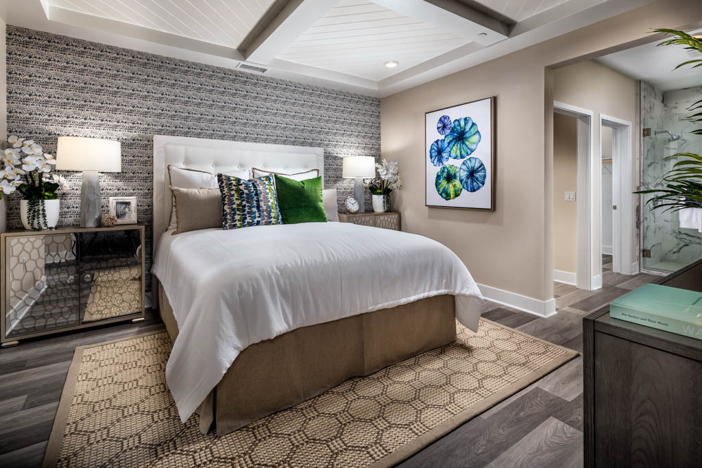 Guest room with detailed print accent wall at Carlyle