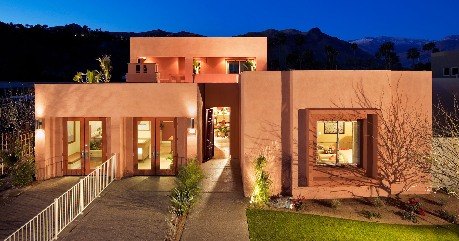 Front view of Luminaire residence at night with exterior lighting