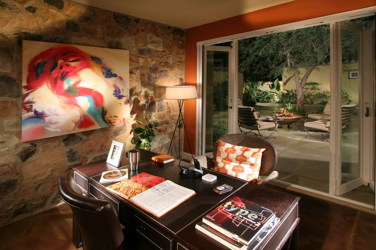 Office area of the Monte Sereno home with red accents and fashion painting on the wall