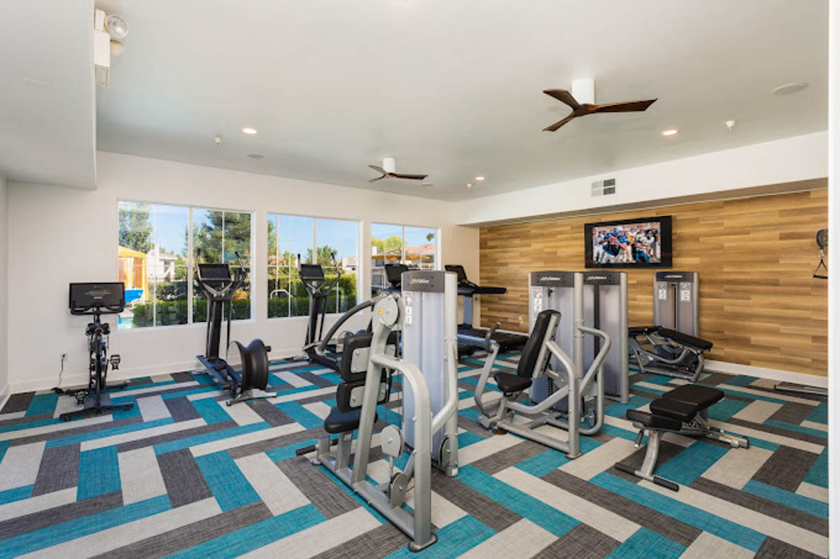 Fitness center with machines and flat screen at the Terraces at Highland development