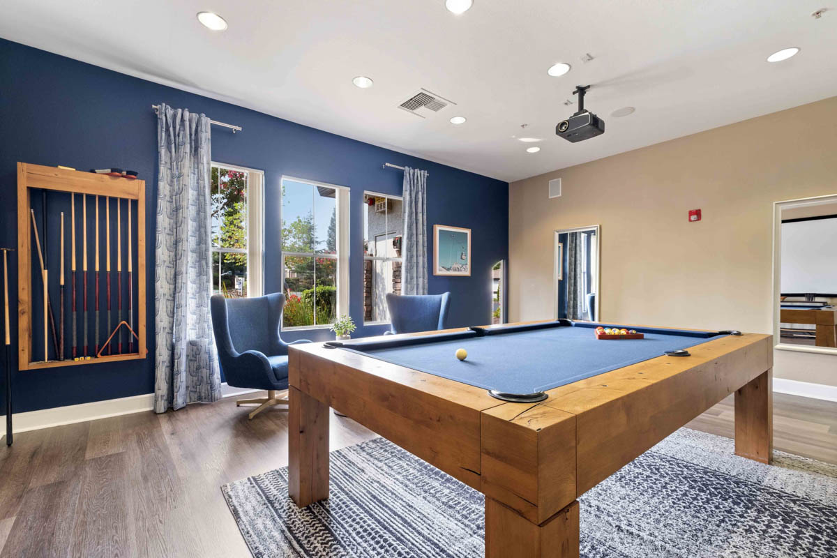 Pool table with blue accent wall at the Terraces at Highland development