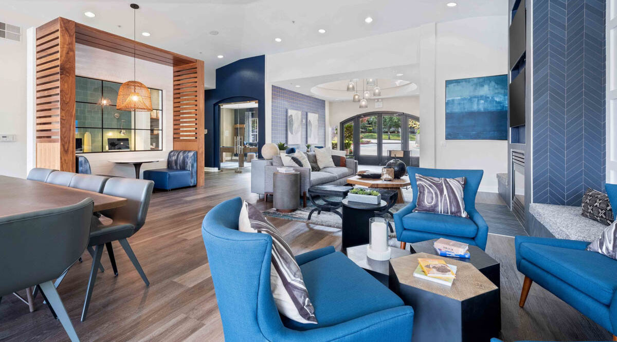 Living room and dining room area with bright blue elements and wood slatted breakfast nook at the Terraces at Highland development