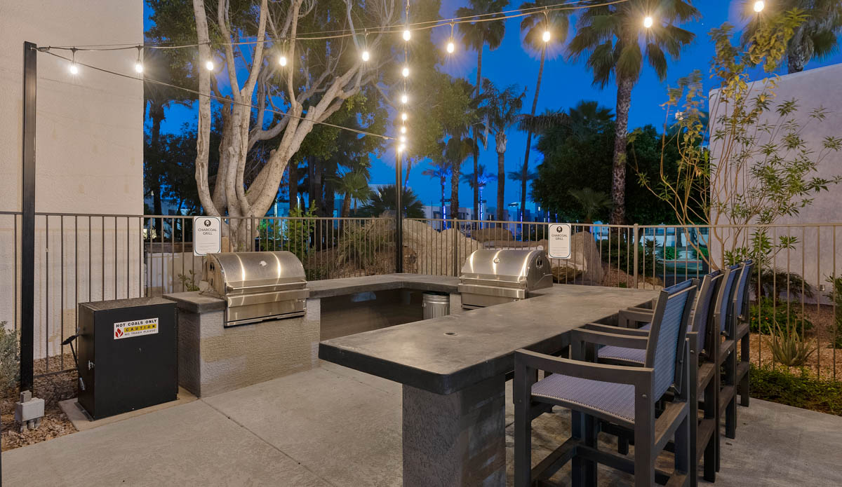 Outdoor grilling and dining area at Paradise Lakes Apartments