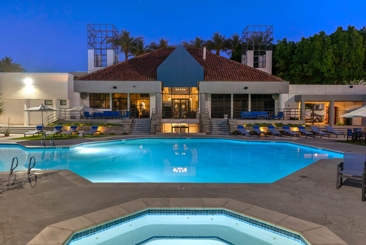 Exterior pool area overlooking pool house at Paradise Lakes Apartments