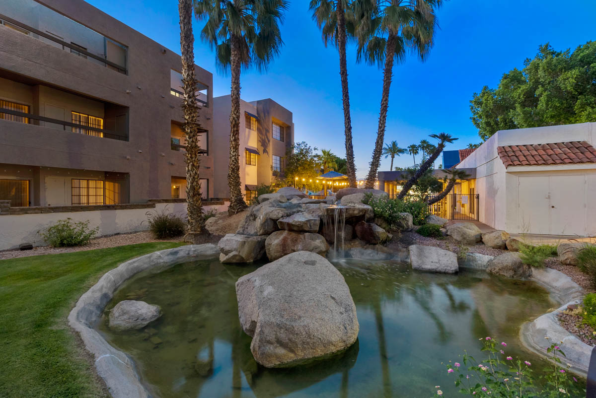 Beautiful waterfall and pond area in front of the Paradise Lakes Apartments