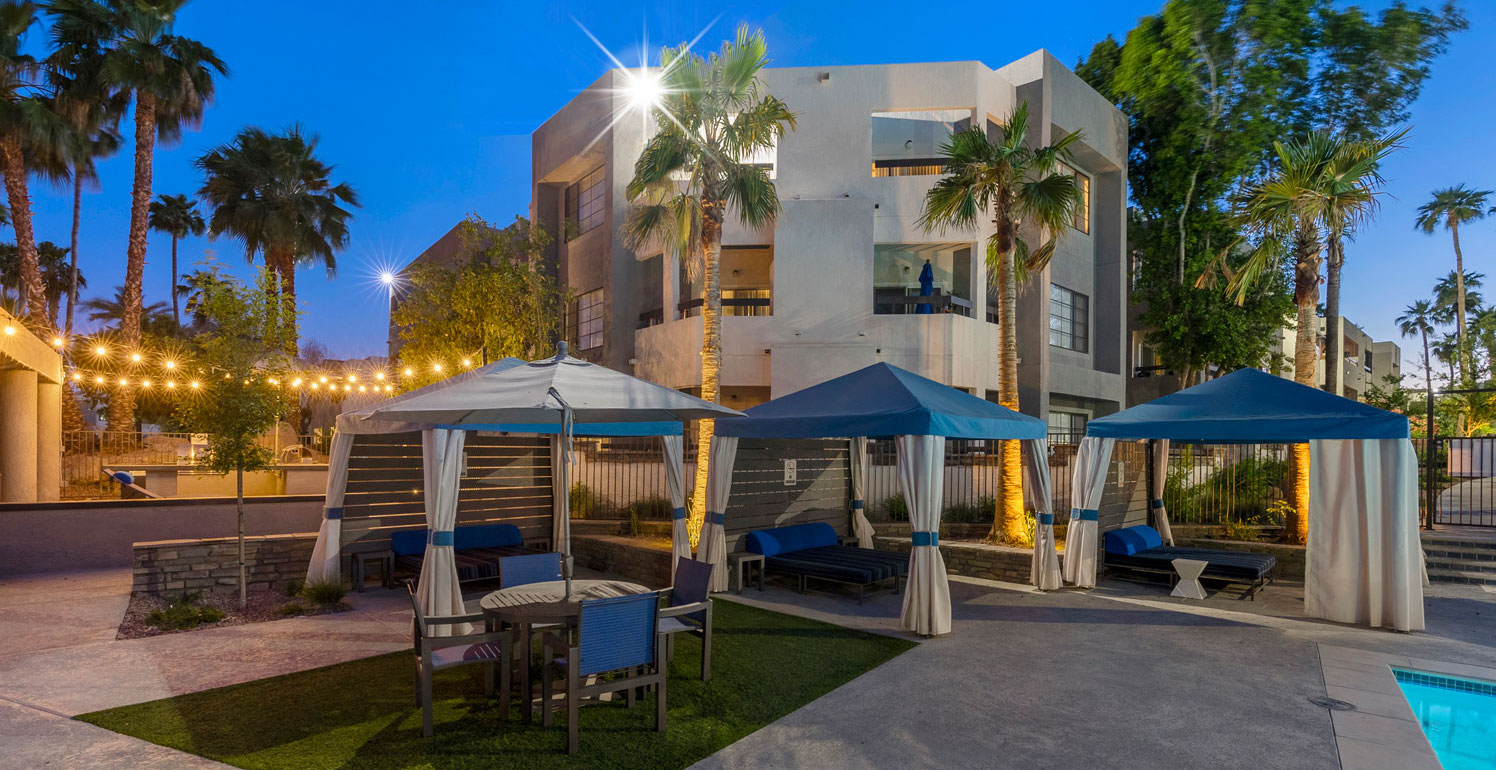 Outdoor canopies around the pool area at Paradise Lakes Apartments with bright light