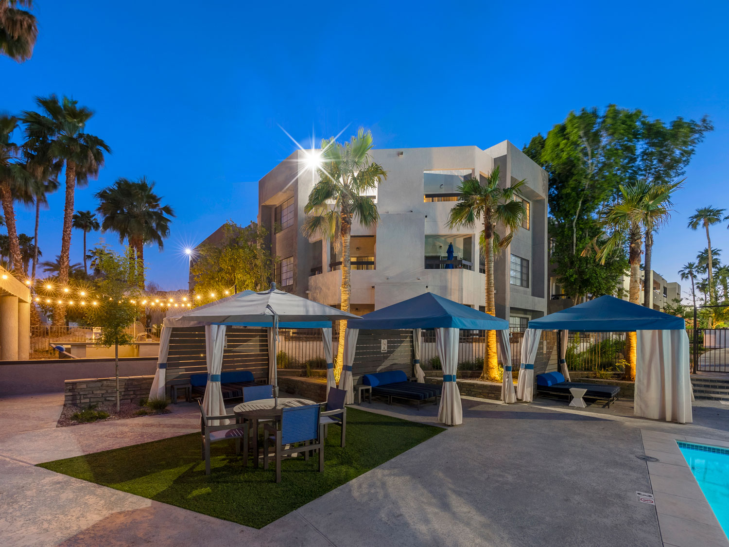 Outdoor canopies around the pool area at Paradise Lakes Apartments with blue sky