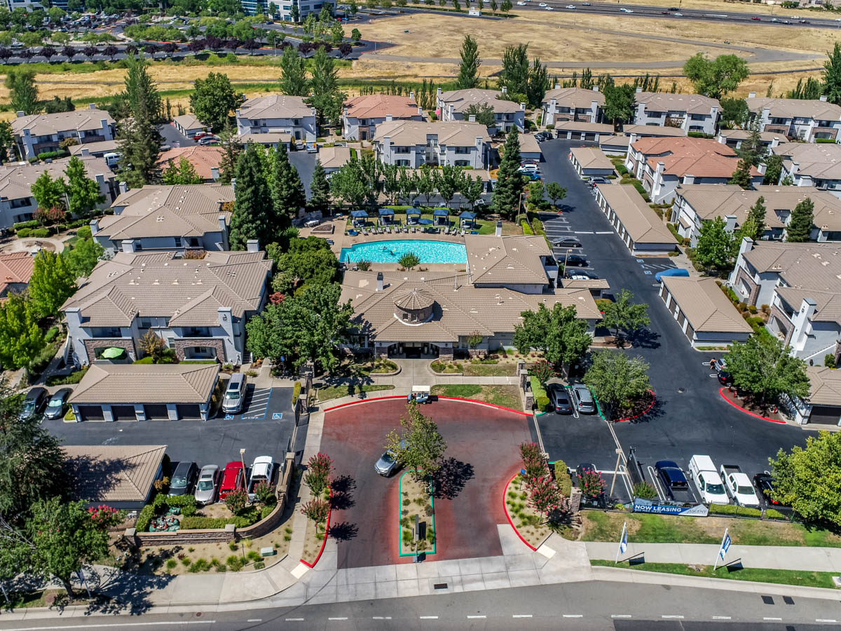 Aerial view to includes developments, pool area, and parking lots at the Terraces at Highland development